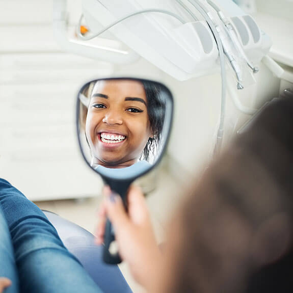 happy-female-patient-looking-in-mirror
